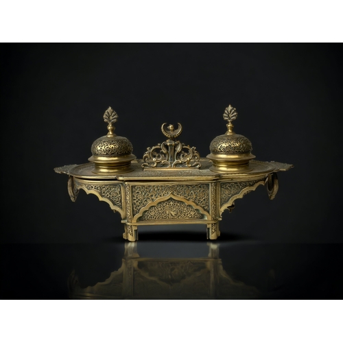 205 - A GILT BRONZE DESK STAND INKWELL.  
19TH CENTURY.
INTRICATELY DETAILED 'PERSIAN' TYPE DESIGN, DEPICT... 