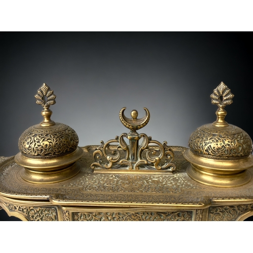 205 - A GILT BRONZE DESK STAND INKWELL.  
19TH CENTURY.
INTRICATELY DETAILED 'PERSIAN' TYPE DESIGN, DEPICT... 