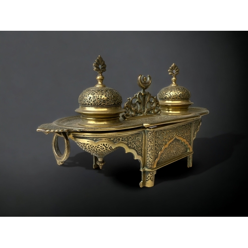 205 - A GILT BRONZE DESK STAND INKWELL.  
19TH CENTURY.
INTRICATELY DETAILED 'PERSIAN' TYPE DESIGN, DEPICT... 