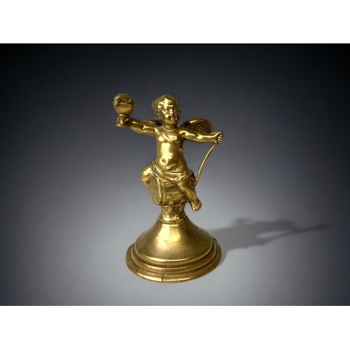 212 - A GILT BRONZE CHERUB FIGURE.
19TH CENTURY.
WINGED CHERUB SAT ON A BARREL. 
HEIGHT - 13CM