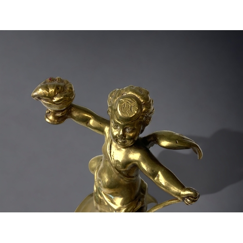 212 - A GILT BRONZE CHERUB FIGURE.
19TH CENTURY.
WINGED CHERUB SAT ON A BARREL. 
HEIGHT - 13CM