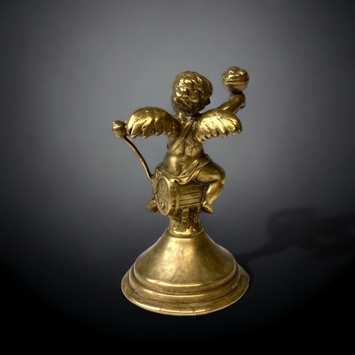 212 - A GILT BRONZE CHERUB FIGURE.
19TH CENTURY.
WINGED CHERUB SAT ON A BARREL. 
HEIGHT - 13CM