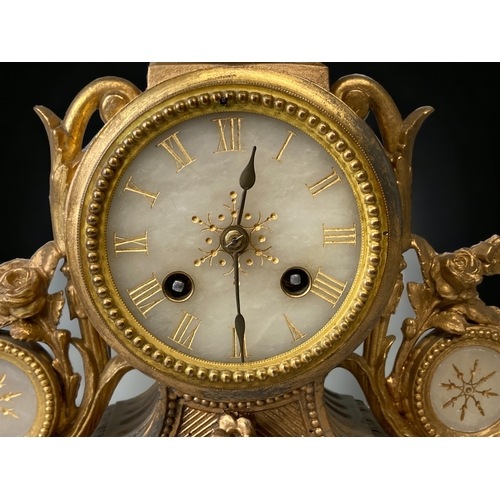 209 - A FRENCH GILT METAL AND ALABASTER MANTLE CLOCK.
CARVED & GILDED ALABASTER FACE WITH ROMAN NUMERALS.
... 