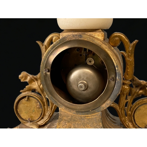 209 - A FRENCH GILT METAL AND ALABASTER MANTLE CLOCK.
CARVED & GILDED ALABASTER FACE WITH ROMAN NUMERALS.
... 