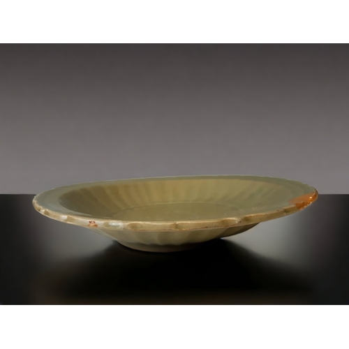 1 - A LARGE CARVED CHINESE LONGQUAN CELADON GLAZED BARBED RIM DISH.
MING DYNASTY.
CENTRALLY CARVED FLORA... 