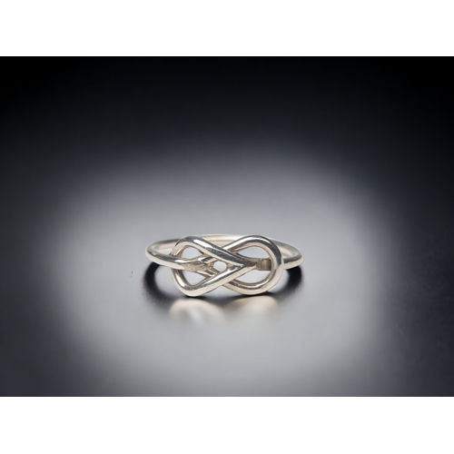 145 - TWO LADIES STERLING SILVER RINGS. INCLUDES ENDLESS KNOT EXAMPLE.