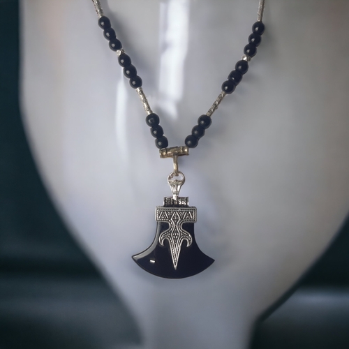 148 - AFRICAN TRIBAL TUAREG PENDANT NECKLACE. SET WITH AXE HEAD SHAPE BLACK AGATE & BEADS.