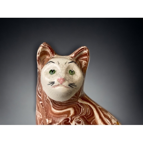 277 - A POTTERY AGATE GLAZE SEATED CAT.
MARKED TO INTERIOR.
HEIGHT - 16CM