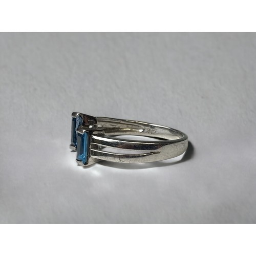 112 - 925 silver ladies designer twist ring set with blue topaz size N