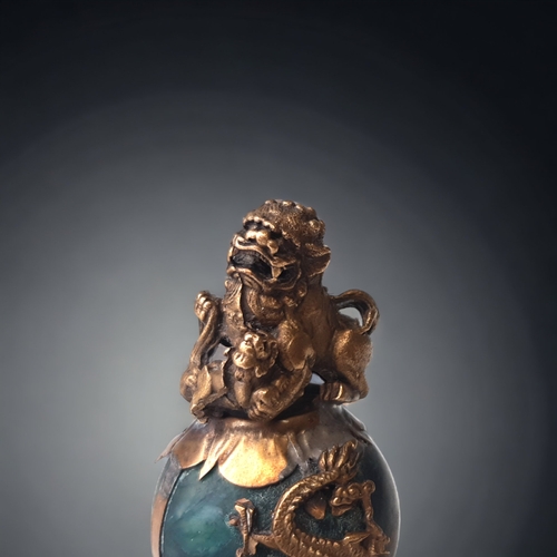 55 - A CHINESE TIBETAN GILT METAL & JADE FO DOG.
GILT METAL LION & CUB ATOP A GLOBULAR JADE BALL SURMOUNT... 