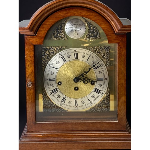 273 - An Oak cased chiming mantel clock 'Tempus Fugit'. 
38.5cms tall.