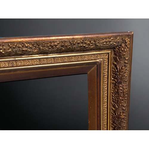 106B - A LARGE VICTORIAN CARVED GILTWOOD PICTURE FRAME. CARVED ACORD DESIGN.
116 X 85CM