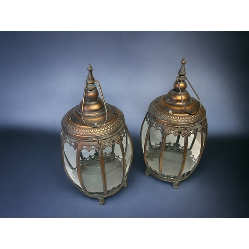 106A - A PAIR OF METAL & GLASS PANELLED HANGING LANTERNS. 
HEIGHT - 48CM