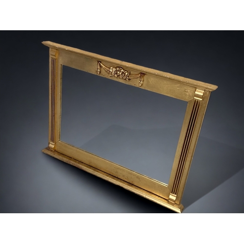 100A - A CARVED GILT-WOOD OVERMANTLE MIRROR.
GLASS IN GOOD CONDITION.