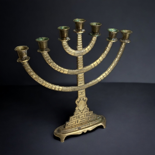 157 - A VINTAGE BRASS MENORAH CANDELABRA, TOGETHER WITH A PAIR OF SMALLER THREE BRANCH CANDLESTICKS. 
HEIG... 