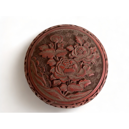 280 - A CHINESE CARVED CINNABAR BOX & COVER. 
5 X 8 CM