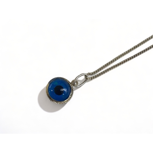 197 - A STERLING SILVER NECKLACE WITH GLASS EYE PENDANT.