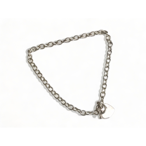 202 - A STERLING SILVER ALBERT CHAIN WITH T-BAR.