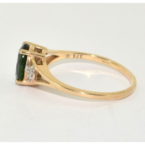 225 - 9ct gold ladies Diamond and Emerald colour centre stone ring size  S