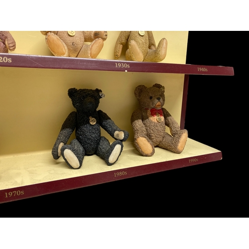 525 - A COLLECTION OF NINE 'A CENTURY OF STEIFF' PORCELAIN TEDDY BEARS. WITH COLLECTORS DISPLAY SHELF.