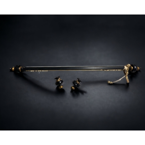 19 - A LARGE GILDED & EBONISED CURTAIN POLE. WITH ADDITIONAL CARVED ENDS.
