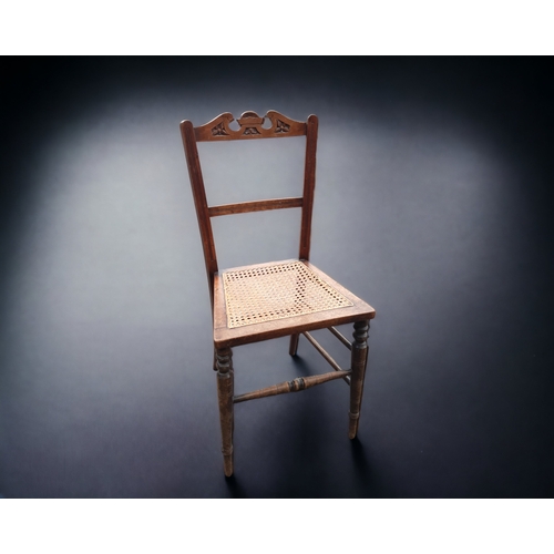 21 - A COLLECTION OF FOUR MISCELLANEOUS VINTAGE CHAIRS. INCLUDING A CARVED CANE SEAT EXAMPLE, TWO WHEELBA... 