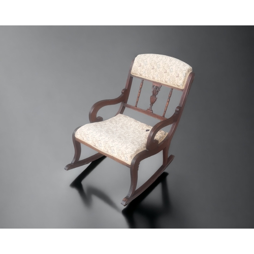 27 - A VICTORIAN CARVED & UPHOLSTERED ROCKING CHAIR.