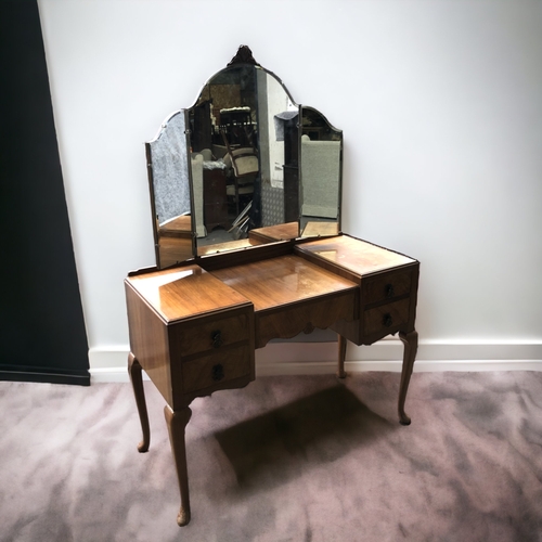 34 - A VINTAGE MID-CENTURY DRESSING TABLE. WITH ADJUSTABLE MIRRORS, FOUR DRAWERS AND CABRIOLE LEGS.