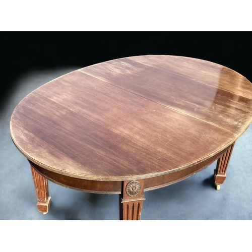 44 - A VICTORIAN MAHOGANY OVAL EXTENDING DINING TABLE. RAISED ON SQUARE COLUMN LEGS, WITH CASTERS.