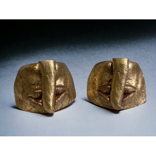 454 - A PAIR OF GILT PLASTER 'SHUSHING' SCULPTURES.
6 X 8CM