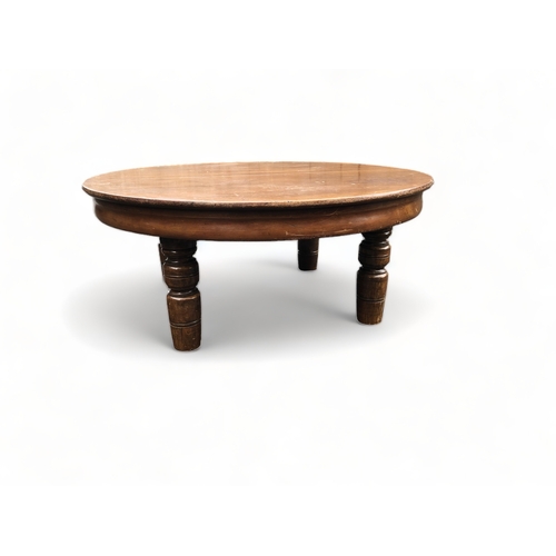 73 - A LARGE ROUND WOODEN COFFEE TABLE