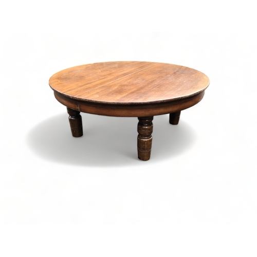 73 - A LARGE ROUND WOODEN COFFEE TABLE