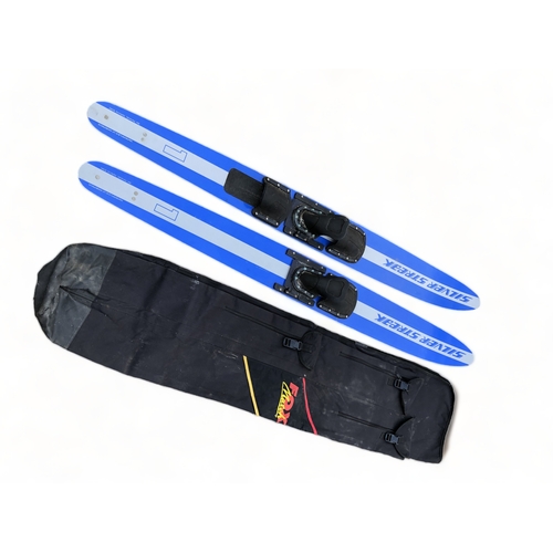 513 - A SET OF SILVER STREAK SKI'S AND COVER