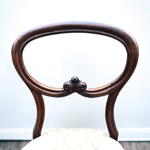 15 - SET OF FOUR VICTORIAN WALNUT BALLOON BACK DINING CHAIRS. ORNATELY CARVED WITH FLEUR-DE-LIS STYLE DES... 