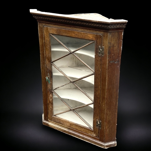 19 - A GEORGE III GLAZED HANGING CORNER CABINET.