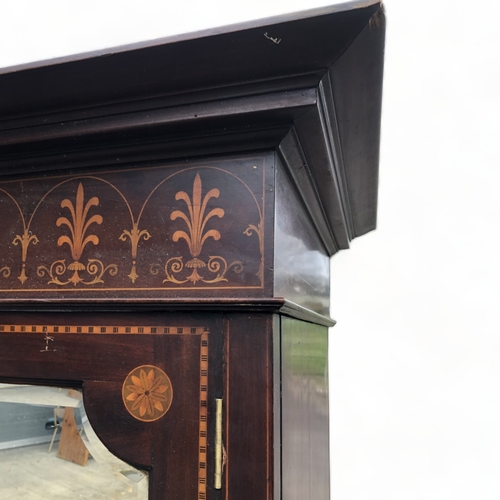 52 - A LATE VICTORIAN MAHOGANY TWIN-DOOR WARDROBE.  INLAID DESIGN, WITH BEVEL EDGE MIRRORED DOORS.