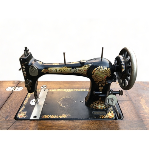 54 - A JONES MEDIUM CS  SEWING MACHINE WITH TABLE. WITH DRAWERS. CIRCA 1914.