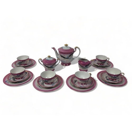 279 - A VINTAGE JAPANESE GEISHA LITHOPHANE TEASET. PINK GROUND WITH RELIEF DECORATED DRAGONS.