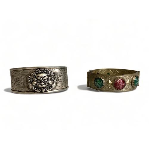 269 - A vintage Tibetan engraved cuff bracelet, together with one other.