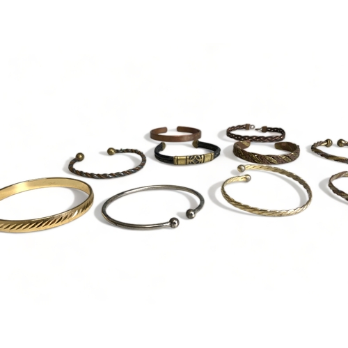 270 - A large collection of Brass & copper bangles.