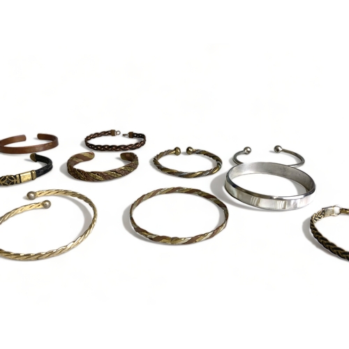 270 - A large collection of Brass & copper bangles.