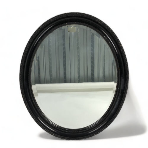 65 - A Gilt plaster wall mirror, together with an Oval wall mirror.