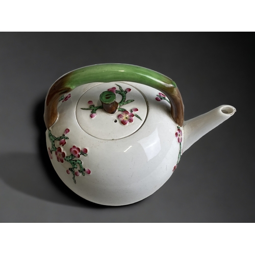 552 - A SCARCE CHRISTOPHER DRESSER FOR MINTON PORCELAIN TEAPOT. CIRCA 1872.
RELIEF DECORATED JAPONESQUE CH... 