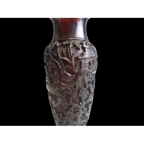 11 - A Chinese deep carved Cherry Amber vase. 
Qing dynasty.
Elaborately carved with landscape scenes, de... 