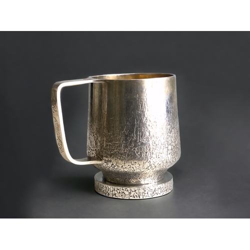 590 - A rare Guy Wilson sterling silver mug.
Bark effect design with inset cabochon to handle.
Makers mark... 