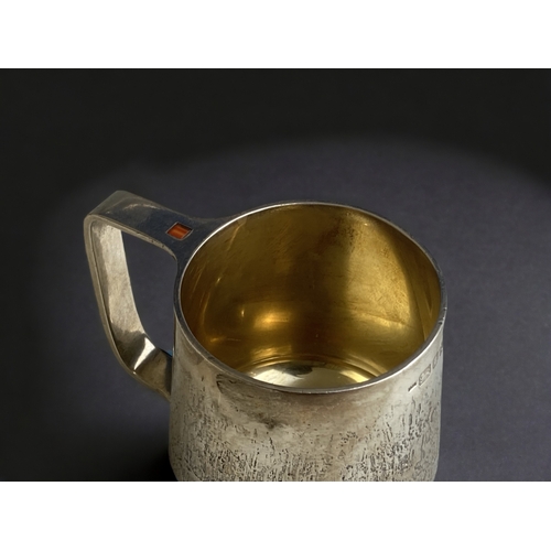 590 - A rare Guy Wilson sterling silver mug.
Bark effect design with inset cabochon to handle.
Makers mark... 