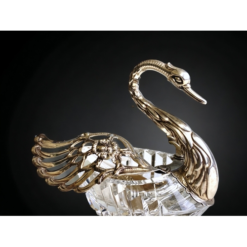 595 - Two sterling Silver & cut glass Swan salts. Together with a silver salt spoon.