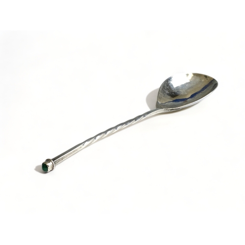 644 - An Arts & crafts sterling silver twist-stem handle spoon. With inset gem.