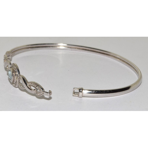 587 - 9ct white gold Aquamarine bangle with clip mechanism