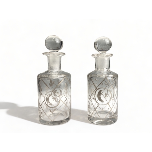 665 - A Pair of 19th century gilded glass scent bottles, each bearing crescent and laurel wreath decoratio... 